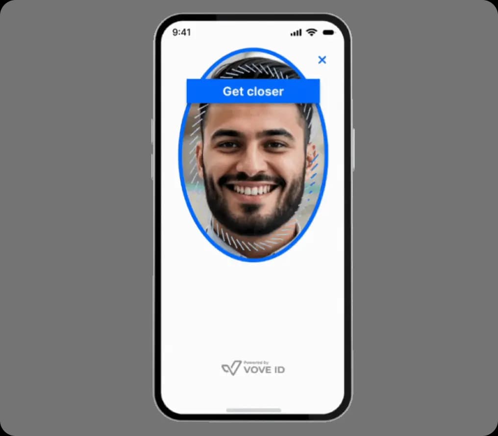 A smartphone screen displays a face recognition process. A man's face is centered within a blue oval, with the text 'Get closer' above it. The VOVE ID logo is at the bottom.